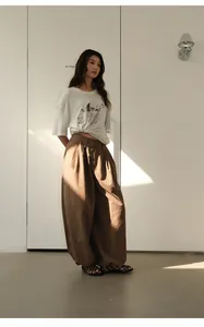 Full-body view of vintage brown checkered baggy trousers with elastic waist and cuffed hem