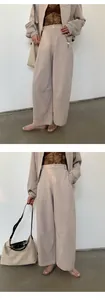 Modern beige two-piece loungewear set with wide-leg pants and jacket