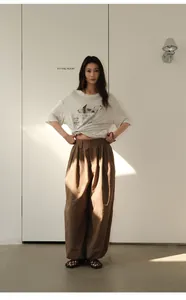 Asian model wearing vintage brown plaid loose trousers and graphic t-shirt in minimalist room