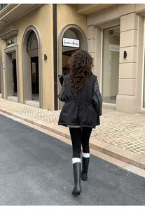 Back view of a woman wearing black warm shark yoga leggings strolling on a European style street.