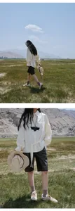 Chic black PU leather wide-leg knee-length shorts for women in a scenic outdoor landscape