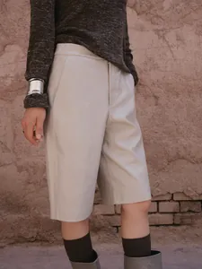 Chic beige PU leather straight bermuda shorts for women, high-quality outdoor lifestyle shot