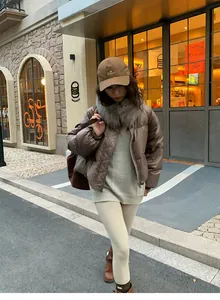 Woman wearing beige thermal yoga leggings in a stylish autumn outdoor street setting