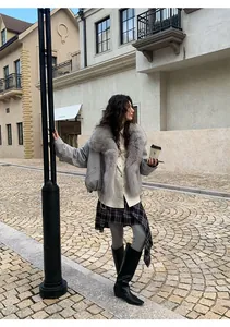Grey shark skin leggings styled with a plaid skirt in a street view setting