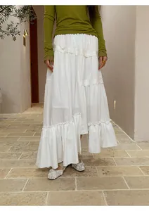 Detail showing white asymmetrical tiered long cake skirt with ruffled hem and texture