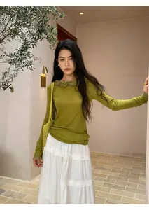 Model wearing a white tiered long cake skirt in a Mediterranean setting
