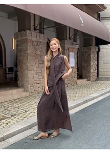 Elegant woman wearing irregular pleated brown maxi skirt in an outdoor street scene