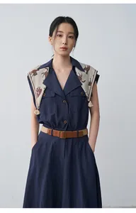 Detail view of navy blue sleeveless lapel dress featuring a decorative horse-print scarf