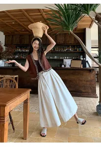 Boho-Ethno-Westen mit V-Ausschnitt und weißen weiten Hosen an einem Model getragen