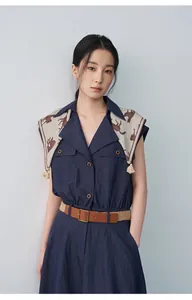 Full length view of a navy sleeveless dress featuring a lapel collar and horse print scarf