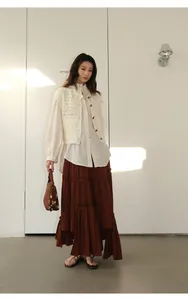 Full body fashion look showing the tiered brown skirt styled for a chic spring outfit