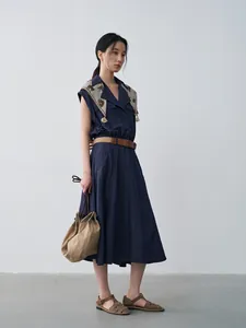 Elegant navy blue sleeveless A-line dress with lapel collar and chic waist belt