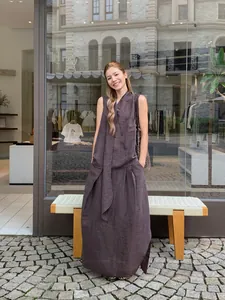 Elegant dark brown outfit with irregular pleated midi skirt for summer style