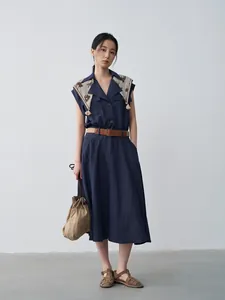 Elegant navy sleeveless lapel dress with decorative scarf and waist-slimming belt
