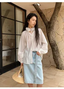 Straight light blue denim midi skirt paired with a white floral collar blouse