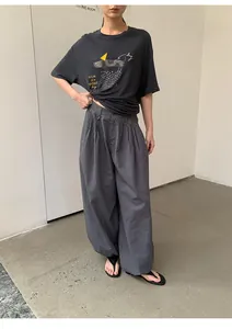 Model wearing retro plaid elastic waist loose casual trousers in a minimalist room