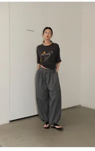 Style shot of retro checkered harem pants with elastic waist and cuffed ankles