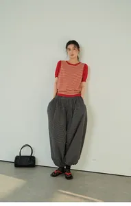 Full body shot of retro plaid loose harem pants featuring elastic waist and cuffed hem.
