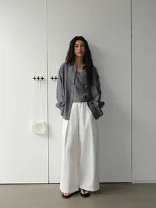 Women's vintage loose casual outfit featuring white wide-leg trousers and a grey shirt