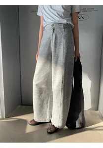 Detailed view of grey casual sickle-cut sweatpants showing the unique fabric and fit.