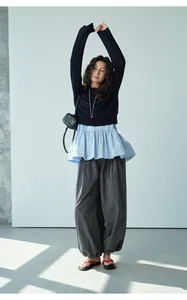 Close-up of retro checkered loose casual trousers featuring comfortable elastic waistband
