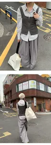 Full length street style view of casual wide leg trousers and grey vest outfit
