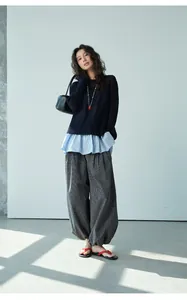 Full view of female model wearing retro plaid elastic waist loose jogger pants in gray