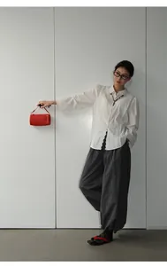 Full body view of woman in retro black and white checkered loose casual pants