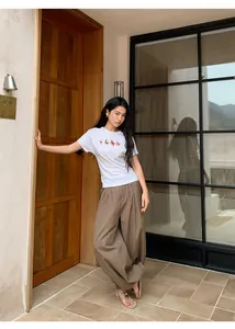 Retro brown checkered loose casual balloon pants for women in outdoor lifestyle setting.