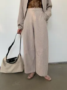 Fashionable beige wide-leg sweatpants and matching zip-up hoodie set for women
