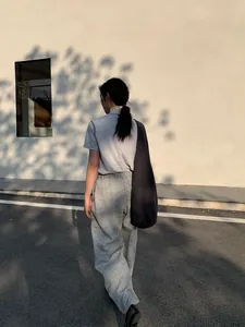 Stylish casual grey wide-leg sweatpants for women in a modern outdoor street style view