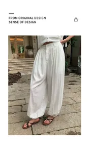 Detailed view of white Lyocell tencel lantern pants on a model in an outdoor setting