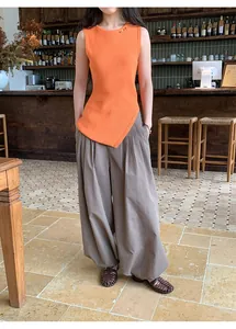 Retro plaid loose casual pants with elastic waist shown on a model in a cafe.