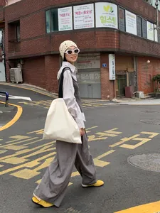 Chic minimalist grey loose-fitting wide-leg trousers for an urban street style look