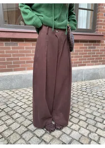 Detailed view of stylish brown floor-length wide-leg trousers for autumn and winter fashion