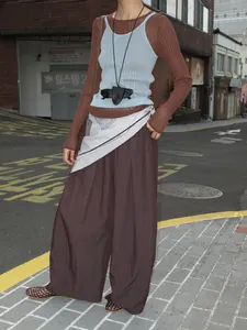 Casual wide-leg brown trousers for women paired with decorative waist scarf