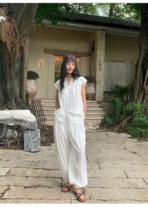 Full-length view of woman in white Lyocell Tencel casual lantern wide-leg pants outdoors