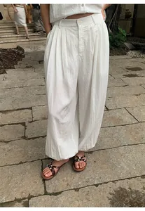 Close-up of lightweight white lyocell lantern trousers featuring elegant pleats