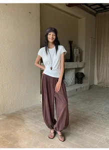 Woman wearing brown Lyocell Tencel casual lantern wide leg trousers in a lifestyle setting