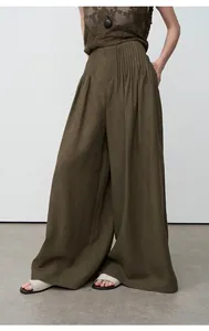 Detail shot of olive green Tencel linen wide-leg pants with elegant pleated waist
