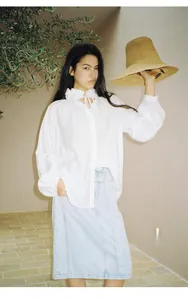 Stylish light blue straight denim midi skirt for women paired with a ruffled white blouse