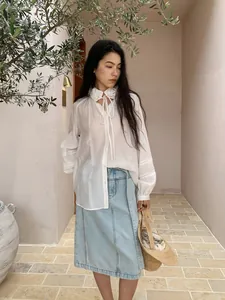 Casual light blue denim midi skirt paired with white floral ruffled lace collar blouse