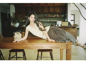Vintage style knitted vest for women shown in a cozy lifestyle cafe setting