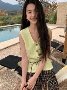 Elegant pale yellow V-neck knit vest with mesh gauze trim for women in resort scene