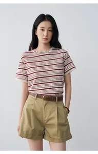 Women's khaki pleated shorts with rolled cuffs and casual striped T-shirt outfit.