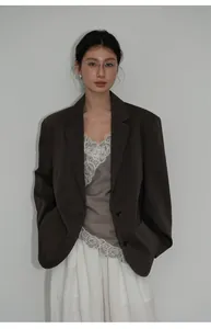 Modella professionale che presenta un blazer casual minimalista marrone scuro oversize da donna