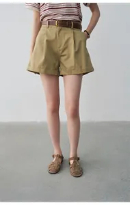 Casual khaki high-waisted pleated shorts with cuffed hem for women's summer style.