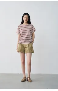 Full body model view of women's pleated mid-waist khaki casual shorts with cuffed hem