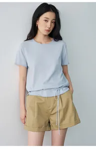 Asian model wearing a minimalist light blue t-shirt and khaki pleated cuffed casual shorts
