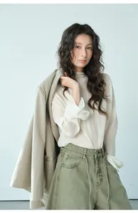 Primo piano di un blazer beige chiaro con camicetta di chiffon bianca per l'autunno